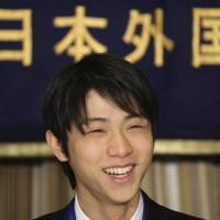 Sochi Winter Olympics men’s figure skating gold medalist Yuzuru Hanyu smiles during a press conference at the Foreign Correspondents’ Club of Japan in Tokyo on Thursday. The 19-year-old athlete is among the 684 people and 23 groups receiving spring decorations from the government. | AP