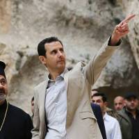 Syrian President Bashar Assad is seen during a visit to the Christian village of Maaloula, near Damascus, on Sunday. State media said Assad visited the historic village, which his forces recently captured from rebels, as the country\'s Greek Orthodox Patriarch vowed that Christians in the war-ravaged country \"will not submit and yield\" to extremists. The rebels, including fighters from the al-Qaida-affiliated Jabhat al-Nusra, took Maaloula several times late last year. | AP