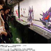 Women look at traditional Japanese swords and replicas of blades that appeared in the animated series \"Neon Genesis Evangelion\" Tuesday in Paris at a preview of an exhibition that opened Wednesday. | KYODO