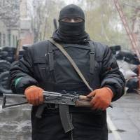 A pro-Russian gunman stands guard at a seized police station in the eastern Ukraine town of Slovyansk on Sunday. | AP