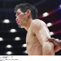 Stick and move: A bloodied Hozumi Hasegawa looks on during the fourth round of his title fight against Kiko Martinez on Wednesday in Osaka. | KYODO