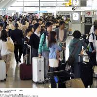 Vacationers heading abroad pack the departure lobby of Narita International Airport in Chiba Prefecture on Saturday as the Golden Week period kicked off. | KYODO