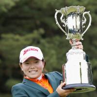 Youth movement: Teenage amateur Minami Katsu holds the trophy after winning the Vantelin Ladies Open on Sunday. | KYODO