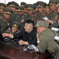 North Korean leader Kim Jong Un (center) inspects a shelling drill Sunday being carried out by a long-range artillery sub-unit tasked with hitting major targets in southwestern waters at undisclosed place in North Korea. | KCNA VIA KNS/REPUBLIC OF KOREA/AFP-JIJI