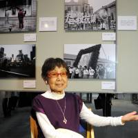Tsuneko Sasamoto, considered Japan\'s first female photojournalist, attends an exhibition of her work at the Japan Newspaper Museum in Yokohama on Saturday. Commemorating her 100th birthday this year, the exhibition features about 130 of her photographs drawn from more than 75 years behind the lens. The show runs through June 1. | SATOKO KAWASAKI