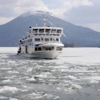 The 188-ton pleasure boat Mashu Maru plows its way through the ice Wednesday on Lake Akan in eastern Hokkaido. The boat is preparing for the opening later this month of the sightseeing route on the lake, known for its \"marimo\" (\"ball seaweed\"). | KYODO