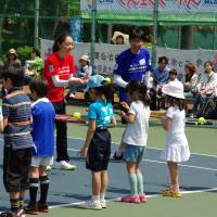 Your serve: Instructors teach kids how to handle their tennis rackets at a pro-tennis clinic during last year\'s Ariake Sports Festa. | TOSHIMI MATSUDA