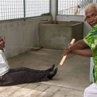 Death comes easy: Anwar Congo, here dressed in a Hawaiian shirt, shows how he killed leftists using a primitive wire apparatus in Joshua Oppenheimer\'s \"The Act of Killing.\" | © Final Cut for Real Aps, Piraya Film AS and Novaya Zemlya LTD, 2012