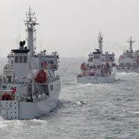Taiwan Coast Guard patrol ships take part in a drill northwest of Kaohsiung in March 2013. Taiwan is building a &#36;100 million port next to an airstrip on Itu Aba Island in the disputed South China Sea. | REUTERS