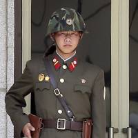 A North Korean soldier stands guard May 14 at the truce village of Panmunjom in the demilitarized zone that separates the two Koreas. | REUTERS