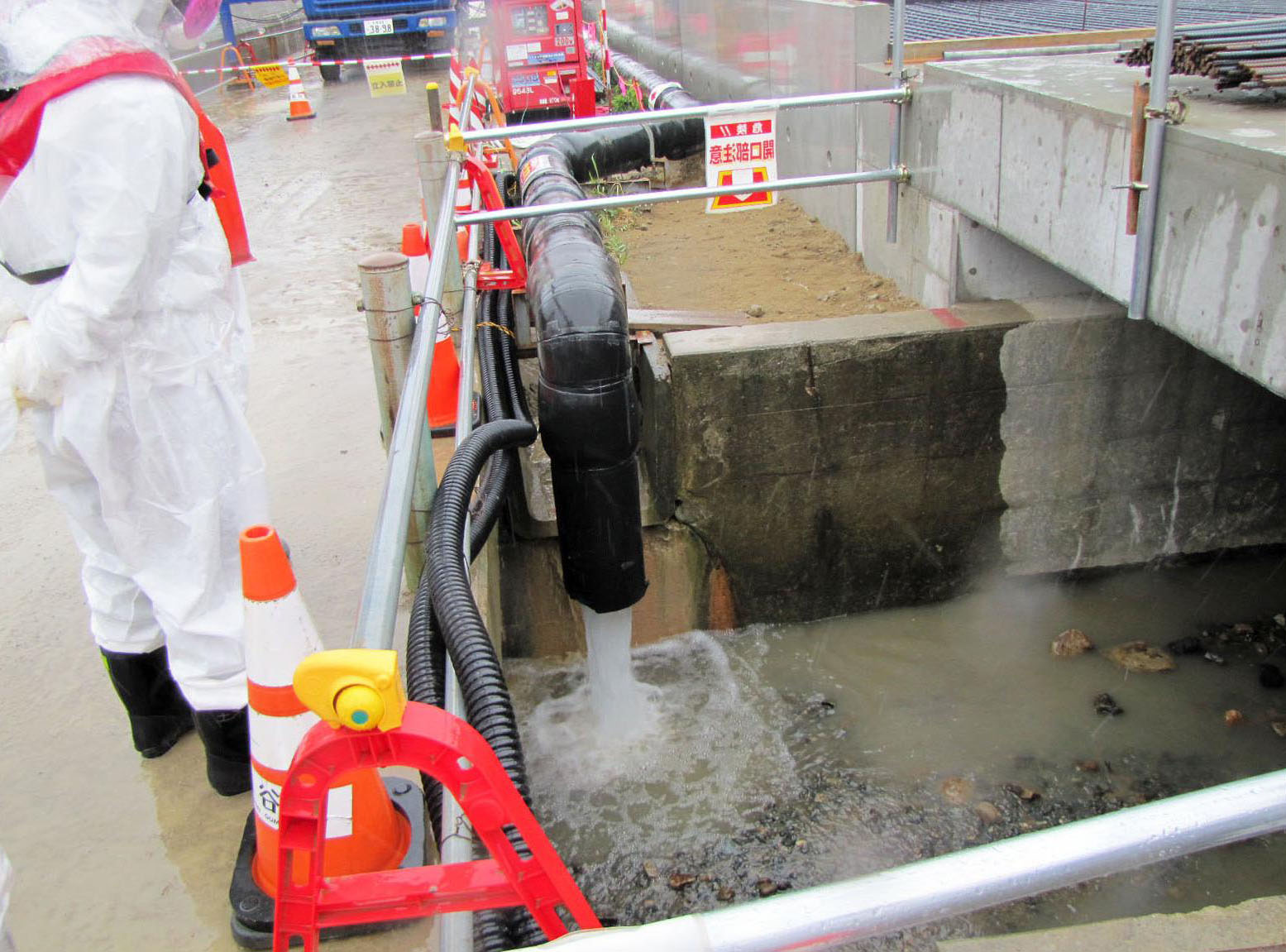 Water is pumped into a drainage ditch at the Fukushima No. 1 plant on Wednesday. | TEPCO/ KYODO