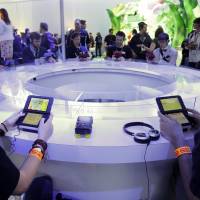 Attendees play games on the Nintendo 3DS at the Nintendo Wii U software showcase during last year’s E3 game show in Los Angeles. Nintendo has said that, despite protest from some fans, it doesn’t plan to allow same-sex romantic entanglements in its English version of the life-simulation game “Tomodachi Life.” Nintendo says 'no' to virtual equality in 'Tomodachi Life'