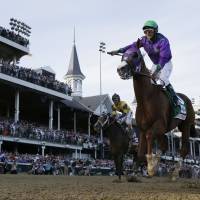 Run for the roses: California Chrome and jockey Victor Espinoza win the Kentucky Derby at Churchill Downs in Louisville, Kentucky, on Saturday in the 140th edition of the classic. | AP
