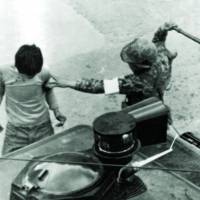 Brutal crackdown: A South Korean soldier clubs a man arrested during anti-government protests in Gwangju on May 20, 1980. | AP