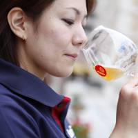 Liquid lunch: A woman tastes craft beer at a festival in Tokyo in 2013. | THE CRAFT BEER ASSOCIATION