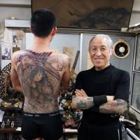 The Master: Horiyoshi III stands alongside a work in progress — some of which can take more than 100 hours to complete. Japan's solitary ode to ink
