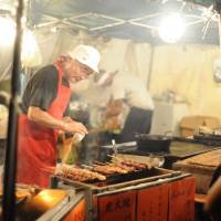 Rare talent: A man grills meat during Earth Celebration on Sado Island. | COURTESY OF EARTH CELEBRATION