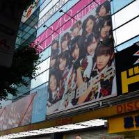 Random violence: Pedestrians pass by the AKB48 Theater in Tokyo\'s Akihabara district last week. Two teenage members of the group and a staffer were injured during an attack by a man with a folding saw at a meet-and-greet event in Takizawa, Iwate Prefecture, on May 25. | AFP-JIJI