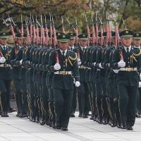 Members of a Self-Defense Forces honor guard march as they prepare to be inspected by U.S. Secretary of Defense Chuck Hagel at the Defense Ministry in Tokyo on April 6. | AP
