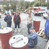 Members of the Minamisoma Council on Farming Revitalization gather on April 22 to receive their share of biodiesel fuel produced from sunflower seeds. | FUKUSHIMA MINPO