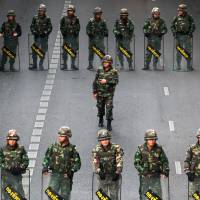 Thai soldiers stand guard to prevent a rally in Bangkok on Thursday. | AFP-JIJI