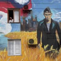 Recent graffiti on a residential building in Sevastopol, Crimea, depicting the Kremlin, Russian President Vladimir Putin and the Russian flag. Moscow calls the peninsula sovereign Russian territory, a claim unrecognized elsewhere. | REUTERS