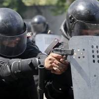 Members of Ukraine\'s security forces take part in a drill in the city of Odessa on Monday to resist and prevent mass unrest ahead of Sunday\'s presidential election. | REUTERS