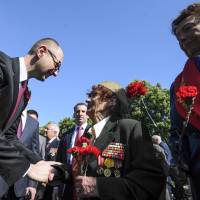 Prime Minister Arseniy Yatsenyuk shakes hands with Ukrainian veterans in Kiev on Friday during a ceremony marking Victory Day, commemorating the defeat of Nazi Germany. Yatsenyuk gains stature with honest image