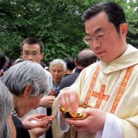 The Rev. Thaddeus Ma Daqin gives Holy Communion outside the Sheshan Basilica in Shanghai in April 2012. | REUTERS