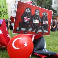 Protesters display a banner depicting Turkish media as the three wise monkeys, who see no evil, speak no evil and hear no evil, outside the Haber Turk TV channel in Istanbul in June 2013. A man who appeared on a Turkish TV dating show this week in search of a new partner shocked the audience by revealing he had murdered his former wife and an ex-lover.  | AP