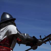 A fighter strikes his opponent with a long sword during the Medieval Combat World Championship in Belmonte, Spain, on May 2, an event that drew an estimated 10,000 spectators. Medieval combat is a full contact sport that includes duels and group battles using long swords, swords and shields, and polearms, and is based on the code of conduct of medieval knights. | REUTERS