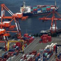 Container cranes work at a shipping terminal in Osaka Bay on May 2. | BLOOMBERG