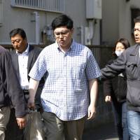 Yoshitomo Imura is taken into custody Thursday in Kawasaki on suspicion of illegal possession of guns made with a 3-D printer.  | KYODO