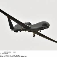 The first of two Global Hawk unmanned surveillance drones flies over the U.S. Misawa Air Base in Aomori Prefecture after arriving early Saturday morning. | KYODO