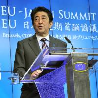 Prime Minister Shinzo Abe and EU Council President Herman Van Rompuy give a press conference on Wednesday at the EU Headquarters in Brussels following the summit meeting between the European Union and Japan. Japan, EU agree to speed up trade talks