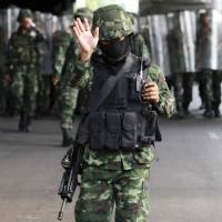 Thai soldiers secure the plaza around Victory Monument in Bangkok on Monday to prevent anti-coup demonstrations in the heart of the capital. Thailand\'s junta leader warned against resistance, or risk a return to the \"old days\" of street violence. | AP