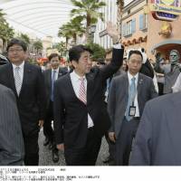 Prime Minister Shinzo Abe tours a casino resort in Singapore on Friday. | KYODO