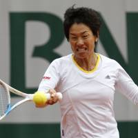 Early exit: Kimiko Date-Krumm returns the ball to Russia\'s Anastasia Pavlyuchenkova during their first-round match at the French Open on Tuesday in Paris. Date-Krumm lost 6-3, 0-6, 6-2. | AP