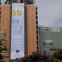 A banner reading \"89-04, May 9 Europe Day\" in memorial of the fall of the Berlin Wall in 1989 and 10 countries joining the European Union in 2004 is on display in front of the European Commission headquarters in Brussels, Belgium. | EUROPEAN UNION