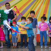 Cultural celebration: A child takes a swing at a pinata at last year\'s Cinco de Mayo Festival in Tokyo. | KYODO