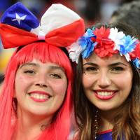 Chile fans smile prior to the start of a Group B match against Australia at the Pantanal Arena in Cuiaba on Friday. | AFP-JIJI
