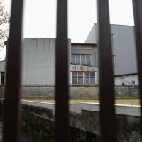 A former Kameda Co. factory used as a dormitory for its Chinese workers is photographed through railings in Hakusan, Ishikawa Prefecture, on April 16. | REUTERS
