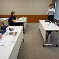 Masashi Miyagawa, manager at Acroseed Co., a Tokyo-based company providing consulting services on foreign worker-related matters, leads a seminar for foreigners interested in starting a business here in Tokyo on June 6. | KAZUAKI NAGATA