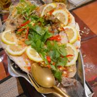 Showpiece: \"Pla neung manao,\" a dish of steamed sea bream with lemon and an array of spices, makes an impressive finale to dinner at Baan Suki. | J.J. O\'DONOGHUE