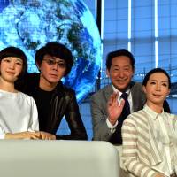 Mamoru Mori (second from right), a former astronaut and the director of the National Museum of Emerging Science and Technology (Miraikan) and Hiroshi Ishiguro (second from left), a professor at Osaka University, pose with humanoid robots Otonaroid (right) and Kodomoroid (left) at the museum on Tuesday. | AFP-JIJI