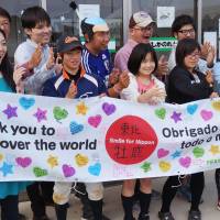 Students at Oshika Junior High School and people involved in sending them to the World Cup in Brazil gather last month at the school in Ishinomaki, Miyagi Prefecture. | KYODO