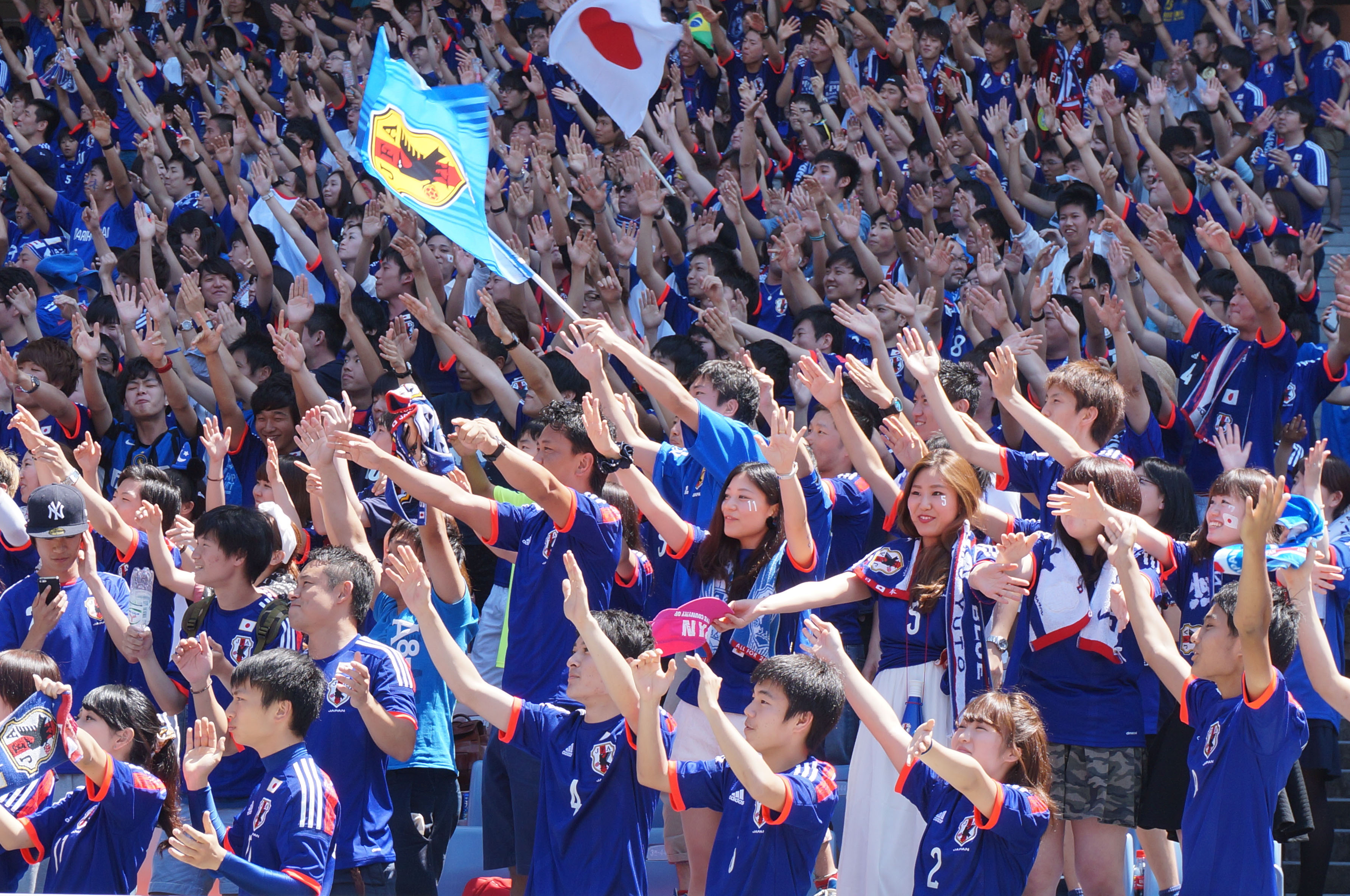 Thousands of soccer fans cheer for Japan on Sunday morning in Nissan Stadium in Yokohama, one of the many public sites where they could watch the team play Cote d'Ivoire during the World Cup in Brazil. Japan lost 2-1. | KAZUAKI NAGATA