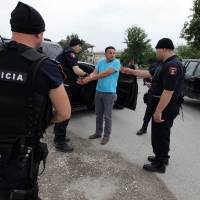 Albanian police arrest a suspect who allegedly shot at them during a raid in Lazarat village, 230 km (140 miles) south of the capital, Tirana, on Tuesday. Police, backed by armored vehicles, came under fire from rocket-propelled grenades, mortars and machine guns. Albanian cannabis growers, 800 police battle in lawless village of Lazarat