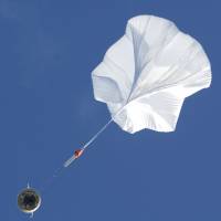 A high-altitude balloon lifts a saucer-shaped test vehicle, which holds equipment for landing large payloads on Mars, at a U.S. Navy facility in Kauai, Hawaii, on Saturday. | REUTERS