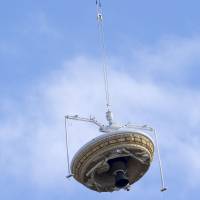 A saucer-shaped test vehicle is raised by a high-altitude balloon at a U.S. Navy facility in Kauai, Hawaii, on Saturday. The vehicle and its giant parachute are designed to deliver heavier spacecraft &#8212;and eventually astronauts &#8212; to Mars. | REUTERS